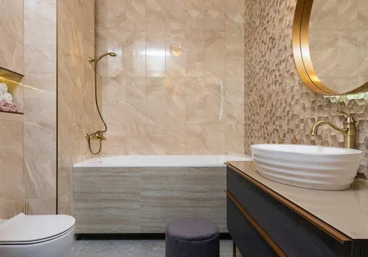 Completed bathroom plumbing installation with freestanding basin and bath